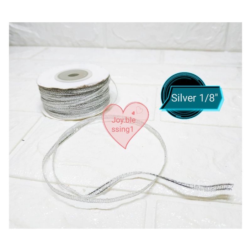 

PITA PERAK SILVER GLITTER 1/8" (0.3 CM) ECER PER ROLL