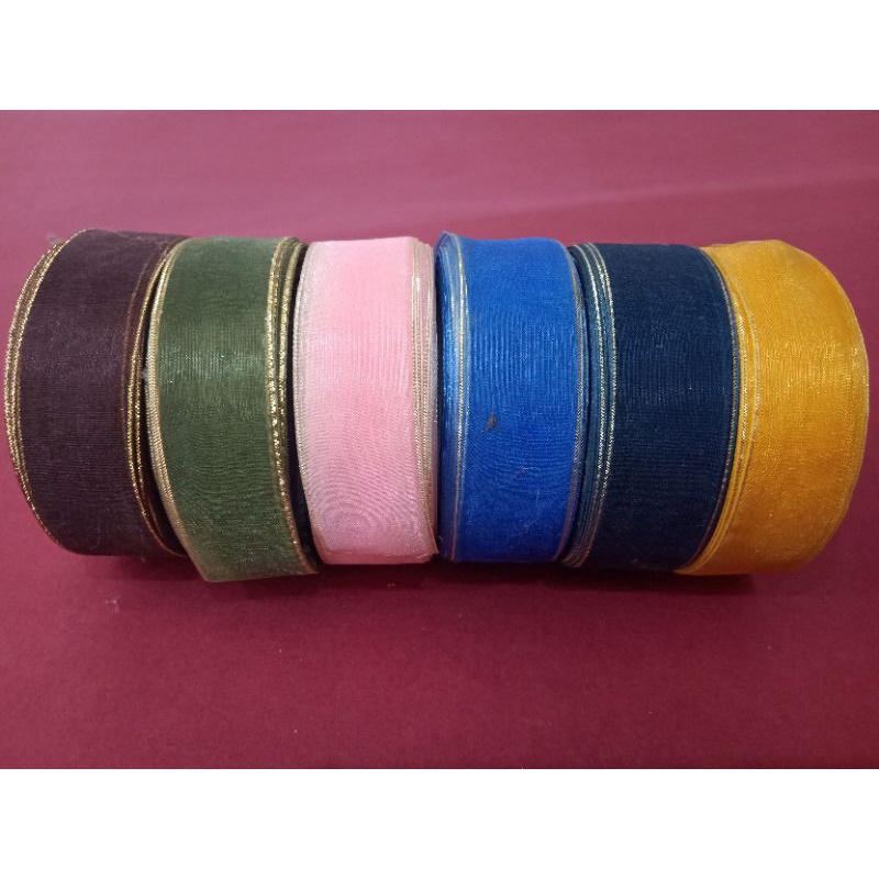 

Pita kain transparan dg garis emas di sisinya dijual per meter