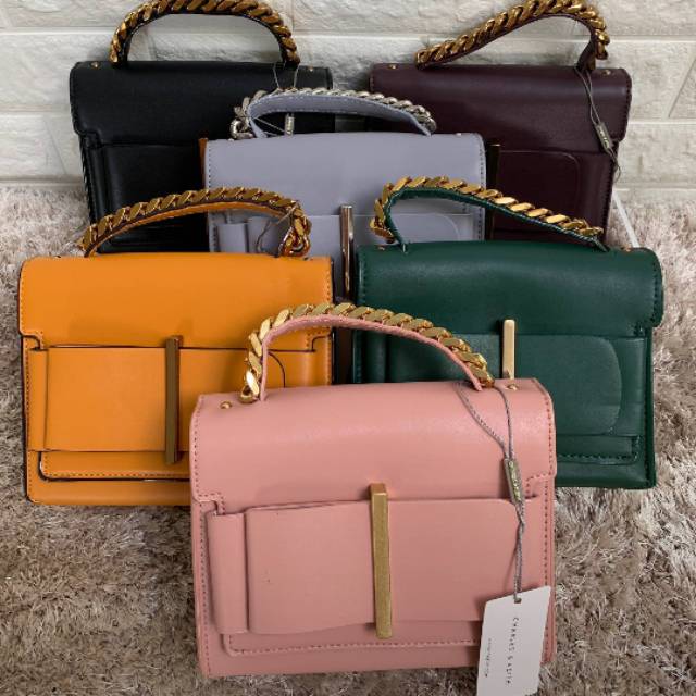 charles & keith chunky metal top handle bow flap bag