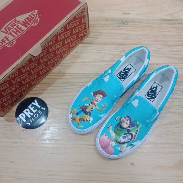 VANS SLIP ON X TOY STORY BABY BLUE MULTICOLLOR AND WAHITE