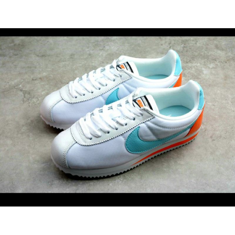 white and orange nike cortez