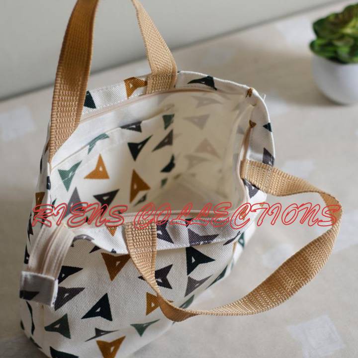 RIENS COLLECTIONS. HANDBAG / TAS JINJING BAHAN KANVAS MOTIF MATA PANAH