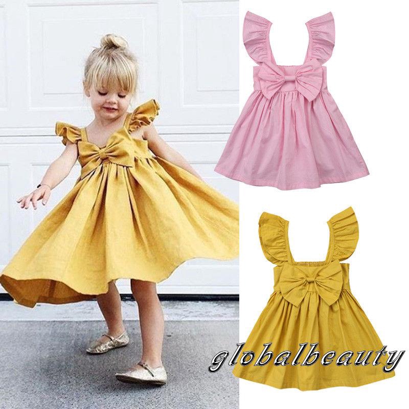 Gaun Anak Perempuan dengan Model Ruffle dan Hiasan Pita Gaun Anak Perempuan dengan Model Ruffle dan Hiasan Pita