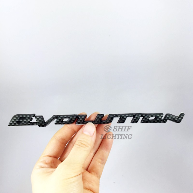 1Pc Stiker Emblem / Badge Motif Evolusi Bahan Carbon Fiber untuk Mobil