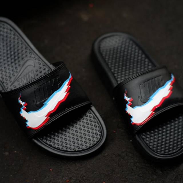 black nike slides with white swoosh