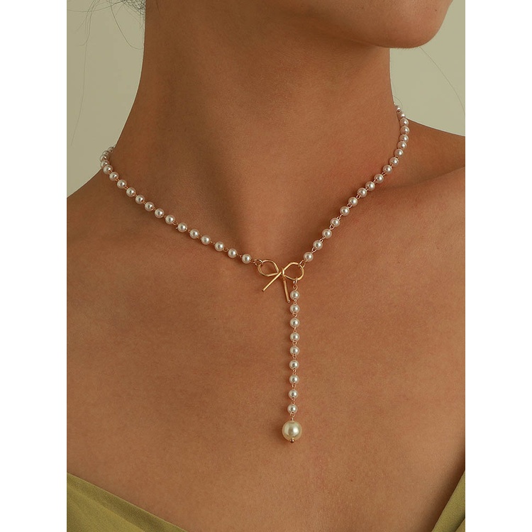 Kalung Liontin Mutiara Model Pita Rumbai Bahan Alloy Gaya Retro Untuk Wanita