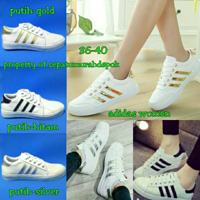 white adidas with gold stripes