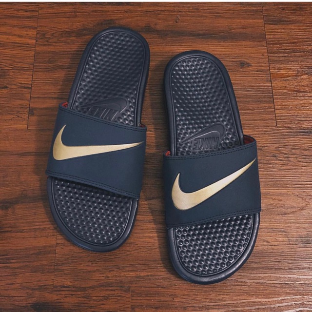 purple nike slides with gold check
