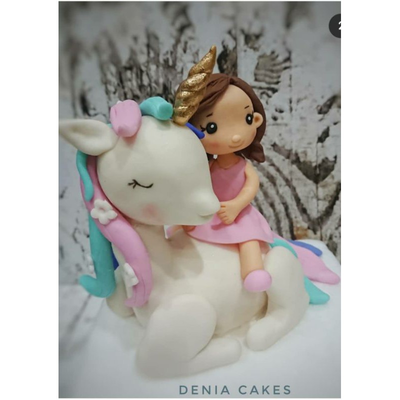 

Unicorn and a girl figurine fondant