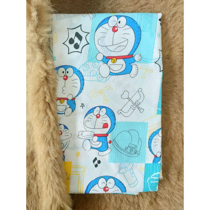 kain perca motif doraemon warna biru muda
