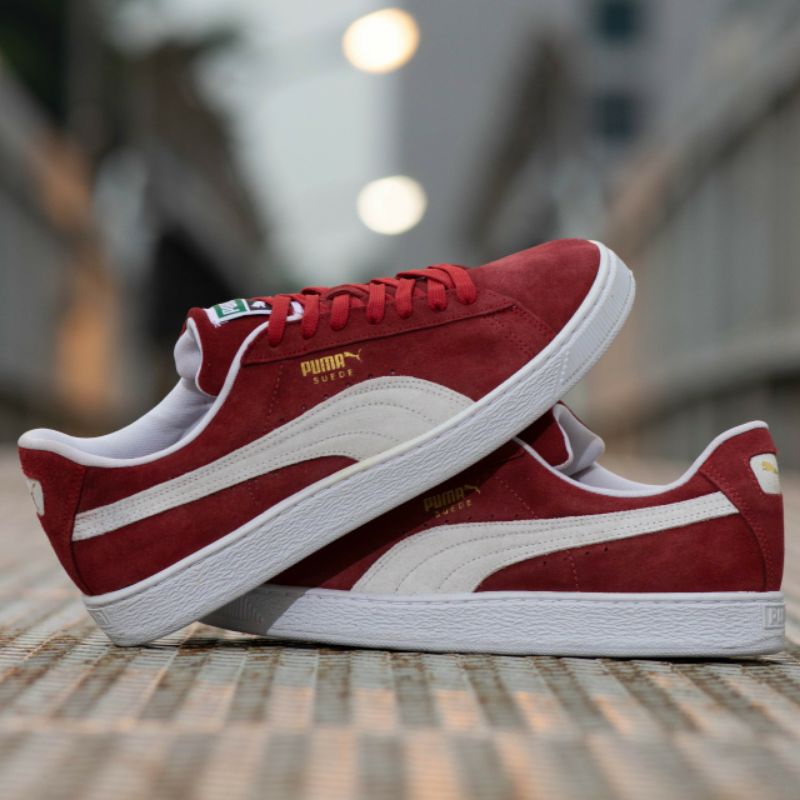 white and red puma trainers