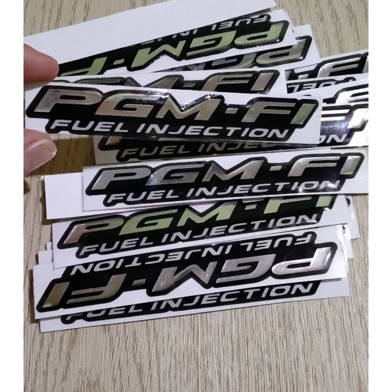 STICKER EMBLEM PGM-FI TIMBUL