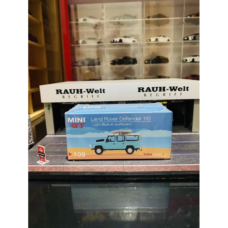 Mini GT No 109 Land Rover Defender 110 Light Blue with Surfboard