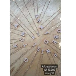 Kalung titanium huruf kecil