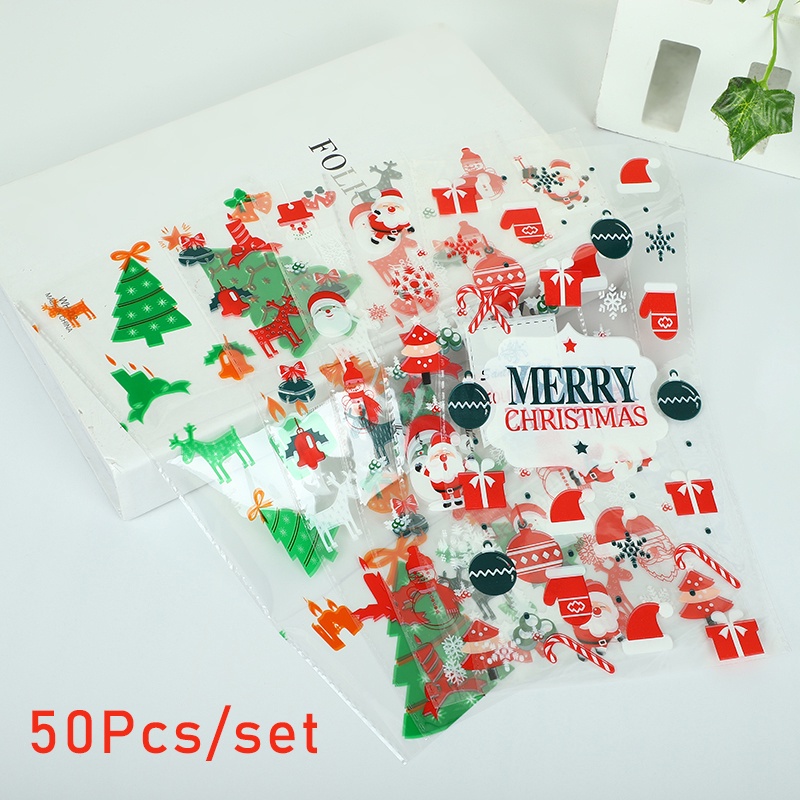 50pcs / Set Tas Pouch Permen / Snack Bahan Plastik Bening Motif Kartun Santa Claus Untuk Dekorasi Pesta Natal