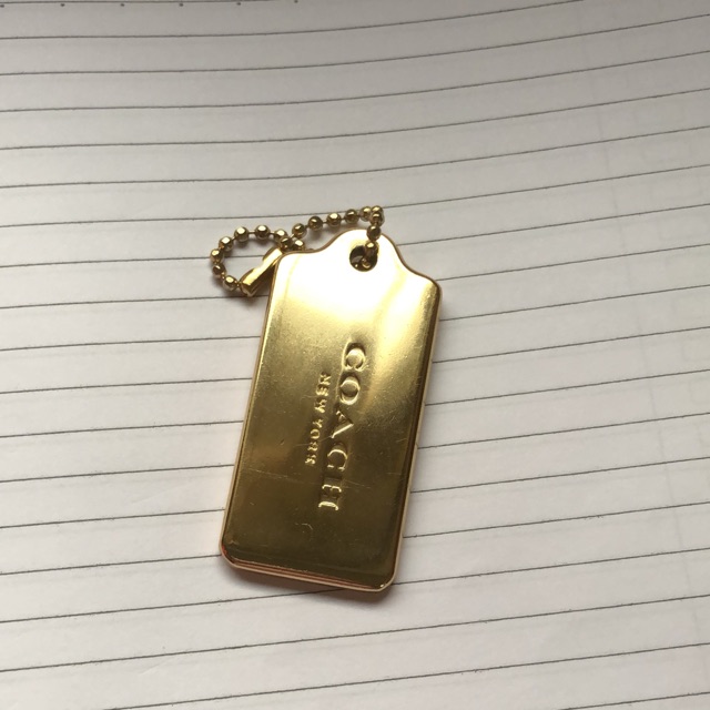 coach gold metal hang tag