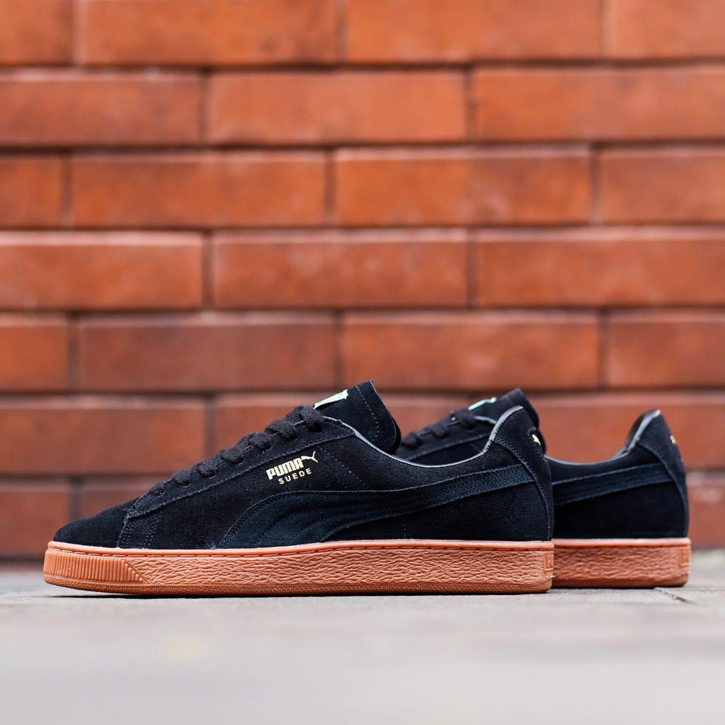 black suede pumas with brown sole