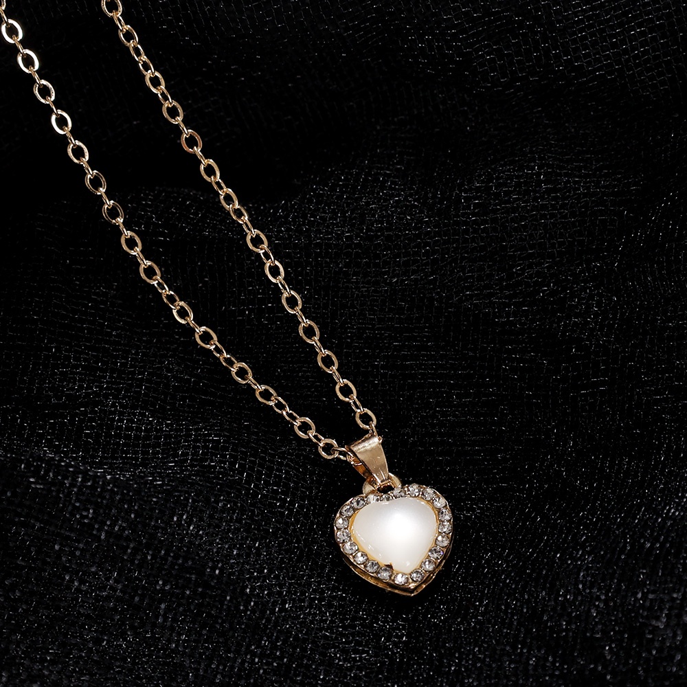Kalung Rantai Klavikula Liontin Opal Bentuk Hati Aksen Kristal Zircon Warna Emas Untuk Wanita