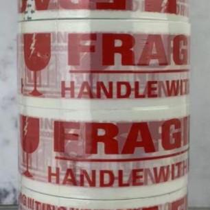 

(BISA COD) lakban fragile putih/solatip fragile jangan dibanting(1 batang-6 roll) BOOM SALE Kode 1222