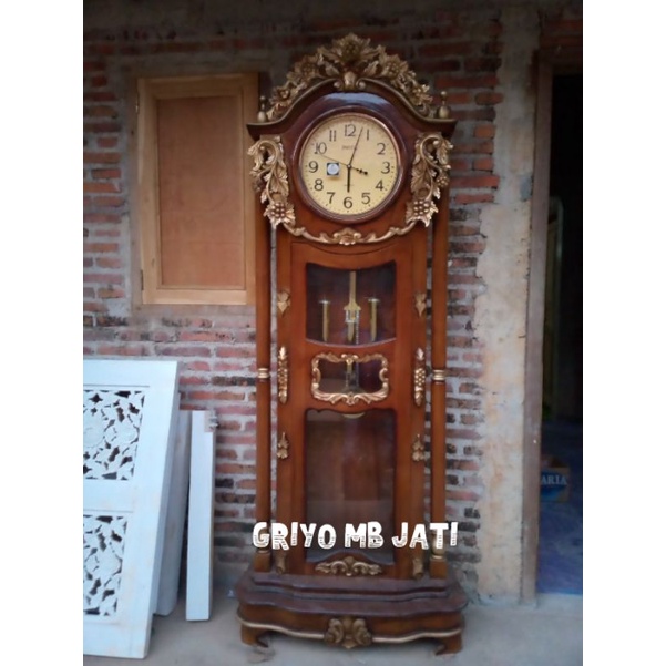 lemari jam hias lonceng ukiran kayu jati