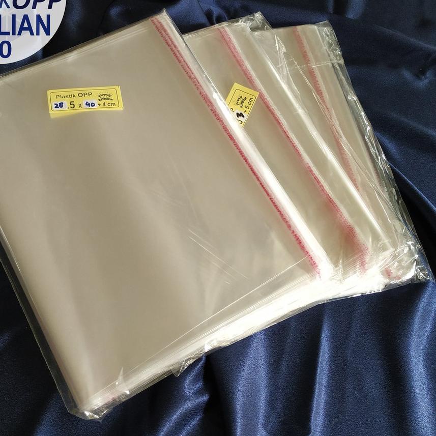 

☺ Plastik OPP 28,5 X 40 CM 20 MIC 100LBR Lem Atau Seal / Plastik bening kemasan bungkus baju gamis celana garment ☞