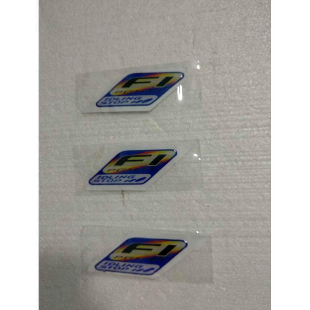 Am- STIKERVTIMBUL - EMBLEM FI IDLING STOP PELANGI