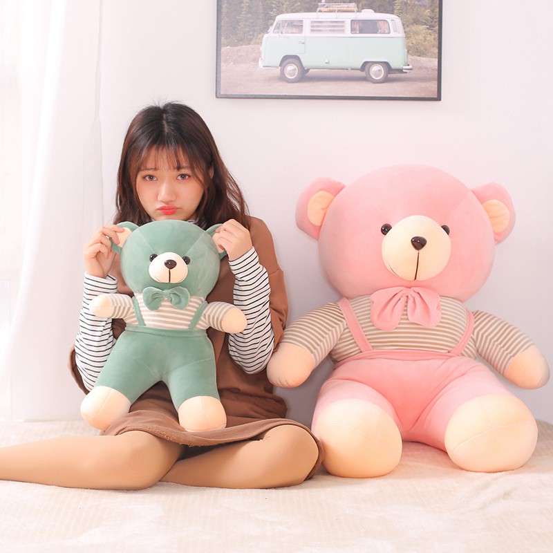 girl hugging a big teddy bear