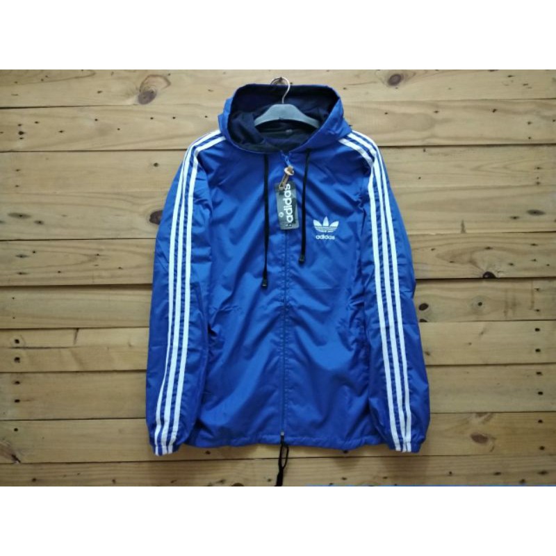 Jaket parasut adidas warna biru list putih