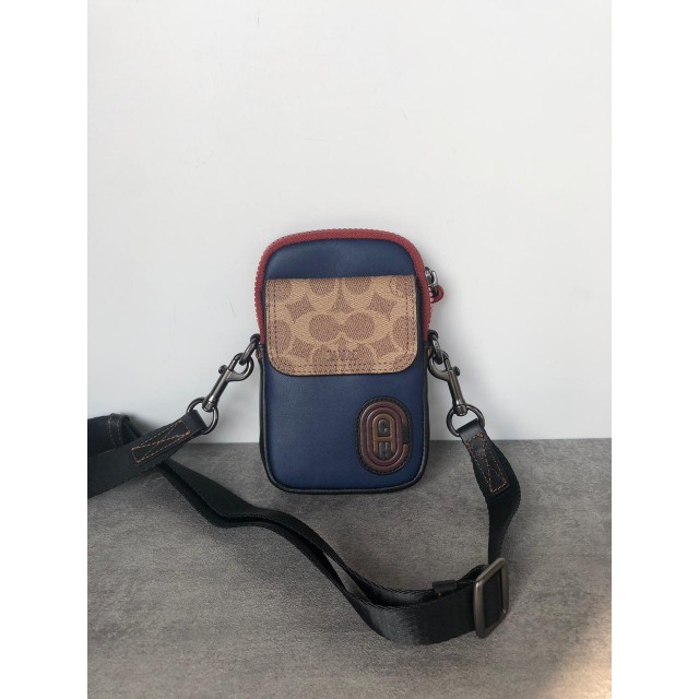 TAS CO PACER CONVERTIBLE POUCH PHONE IN COLOR BLOCK SIGNATURE CANVAS WITH COACH PATCH