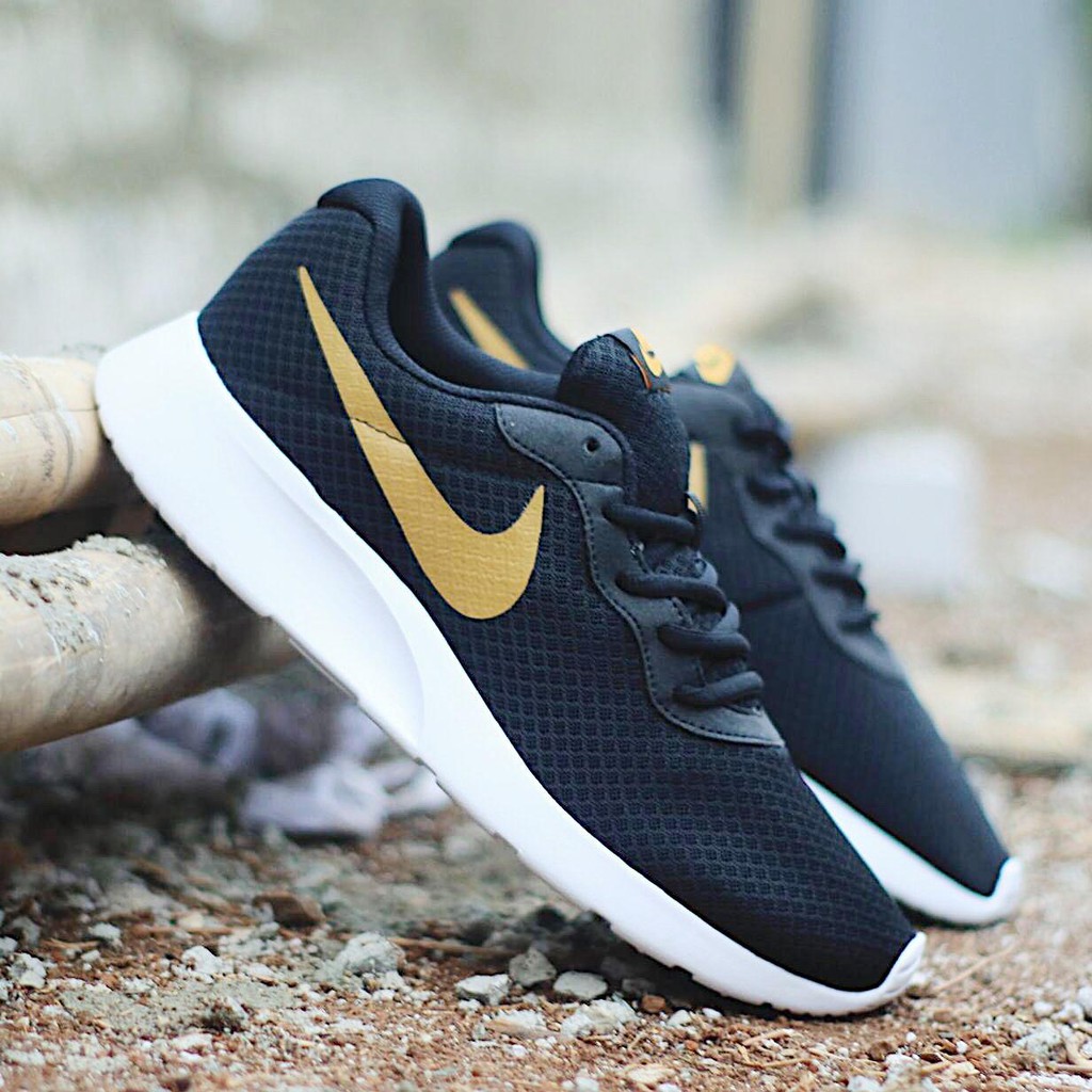 black nike shoes gold swoosh