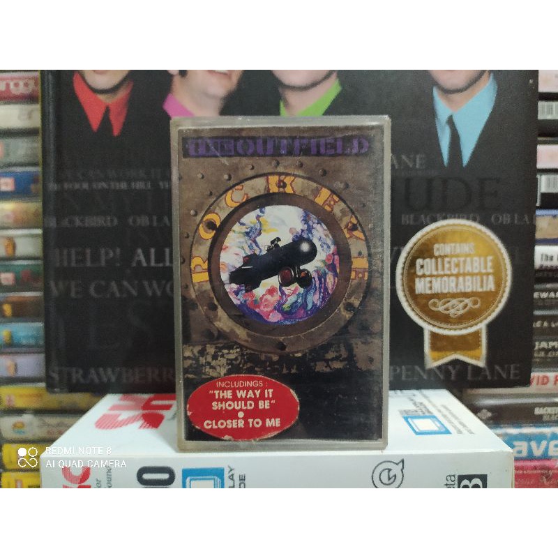 Kaset Pita : THE OUTFIELD - ROCKEYE.