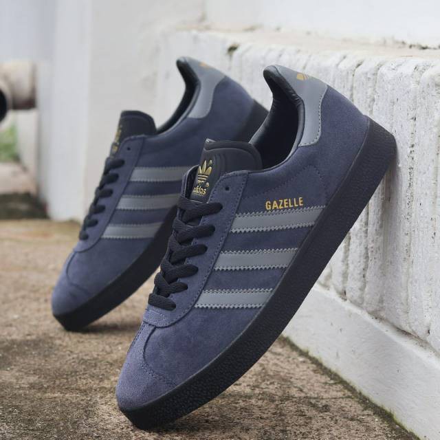 grey and black adidas gazelle