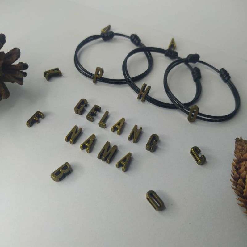 GELANG TALI HITAM/GELANG  COUPLE MAGNET INISIAL SLIDE BRONZE .