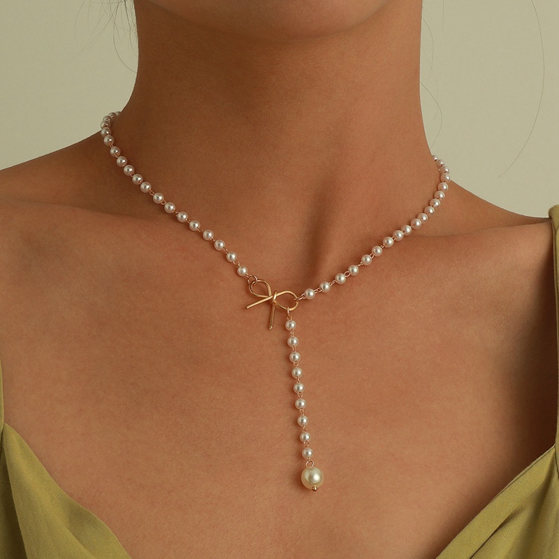 Kalung Liontin Mutiara Model Pita Rumbai Bahan Alloy Gaya Retro Untuk Wanita