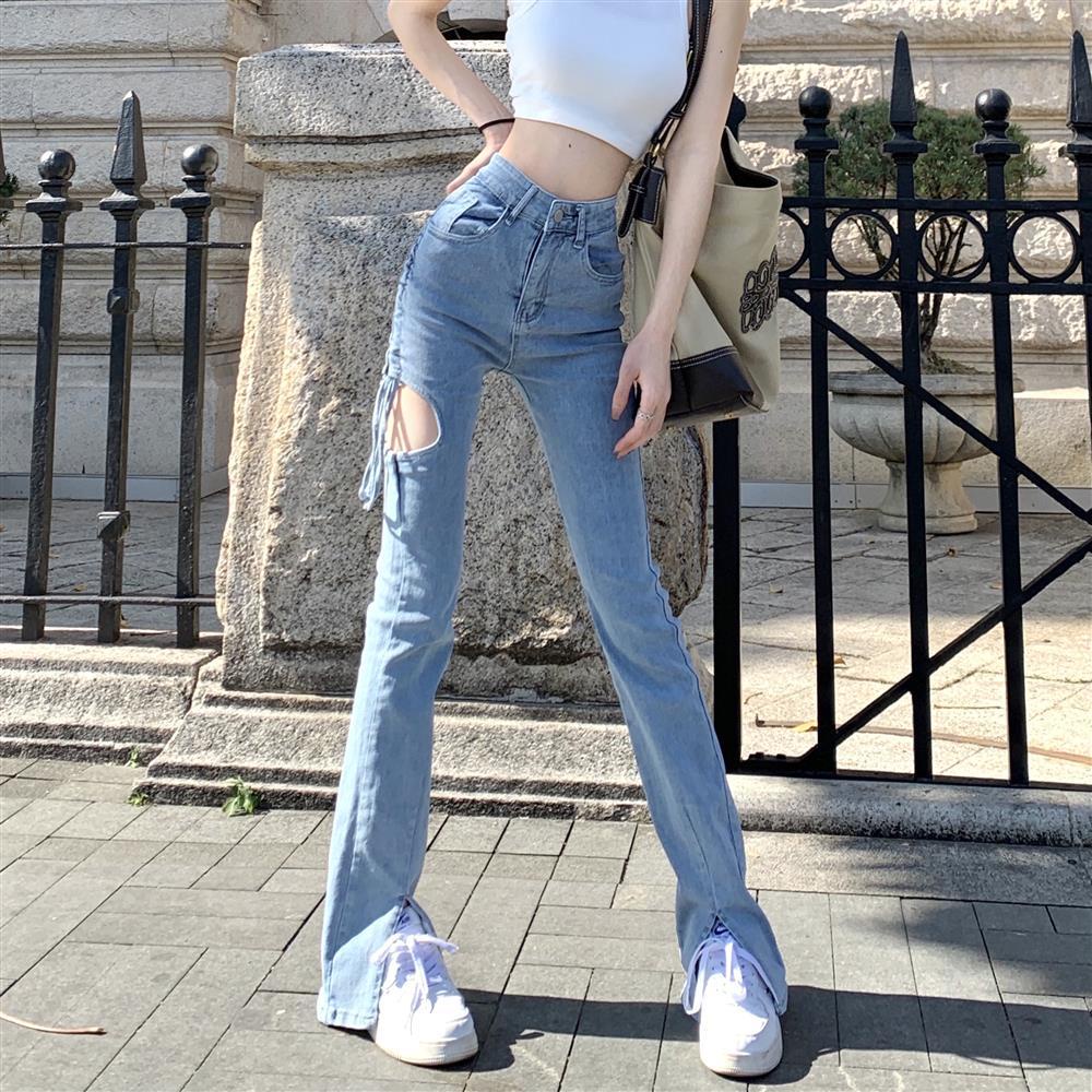 Red Hot girl micro-horn high-waisted jeans wanita musim panas desain rasa lubang split mengepel celana longgar lurus celana trendi