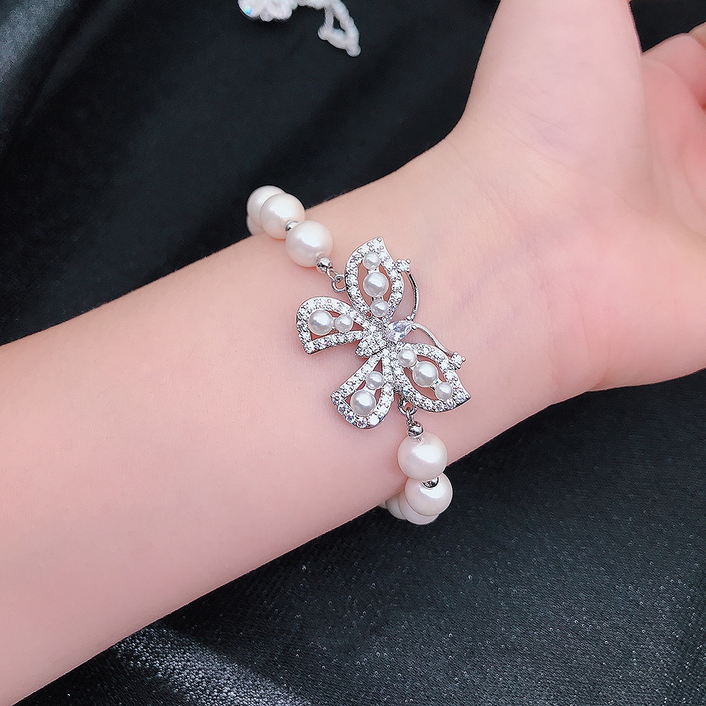 Gelang Adjustable Bahan Stainless Steel Aksen Kupu-Kupu Dan Mutiara Untuk Wanita