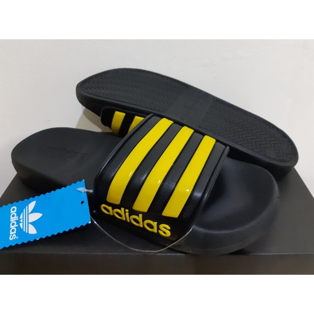 yellow adidas flip flops
