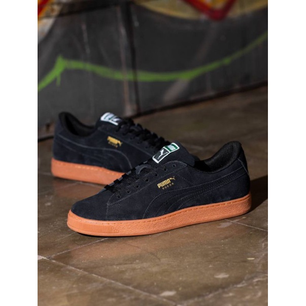 black suede pumas with brown sole