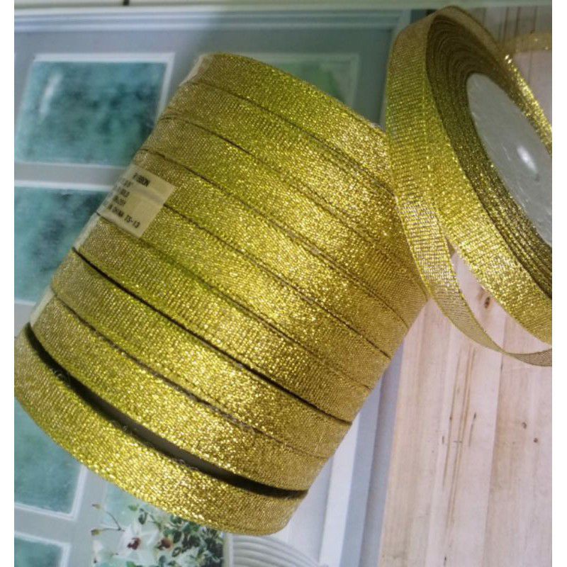 

per rol 25 yard/22.5 meter,organdi glitter emas lebar 1 cm