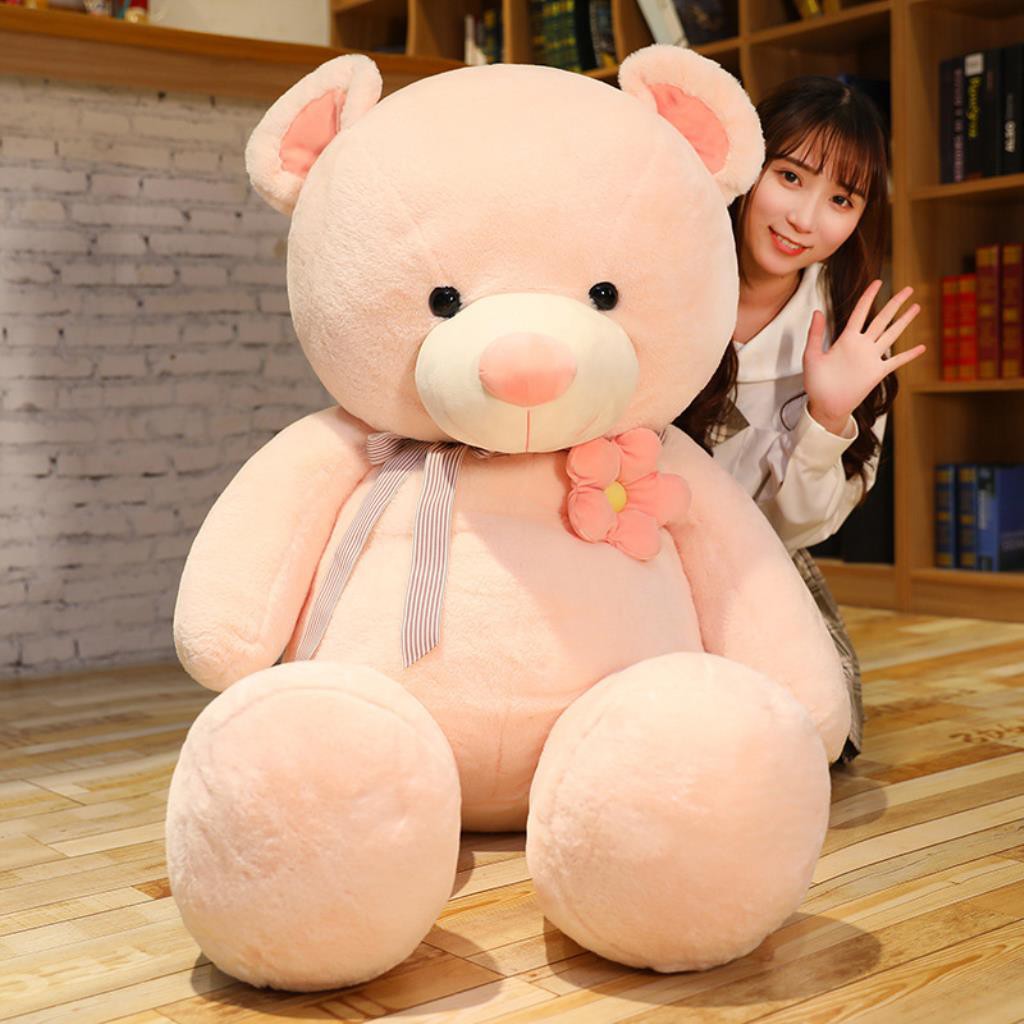 girl hugging big teddy bear