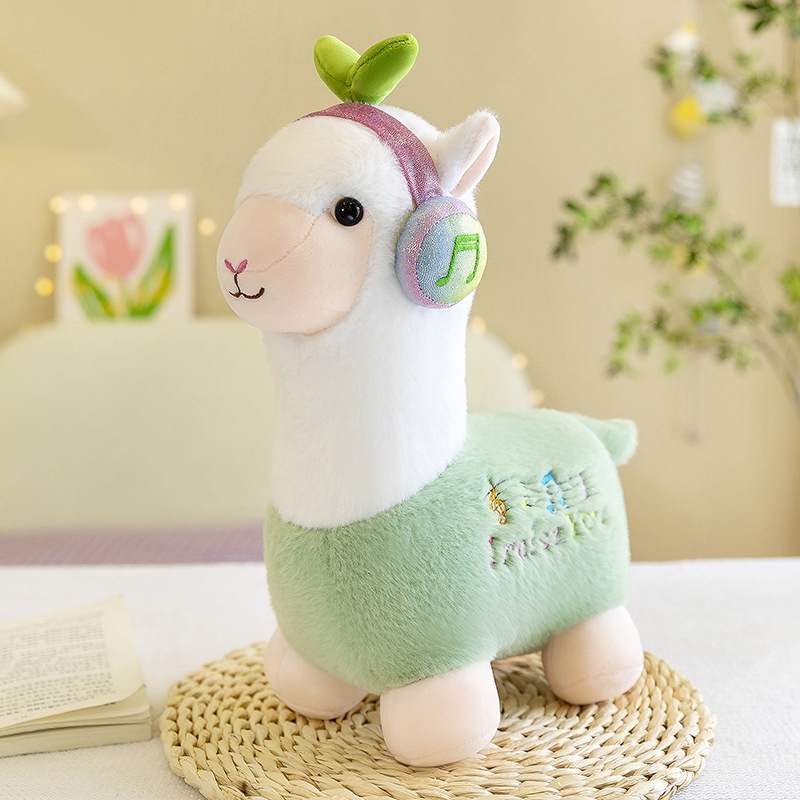 Boneka alpaca dengar musik