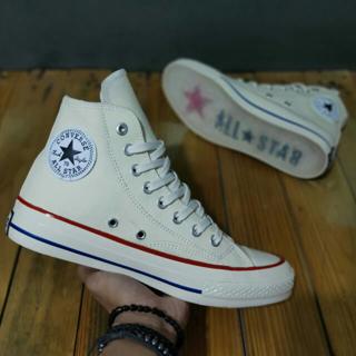 white patterned converse
