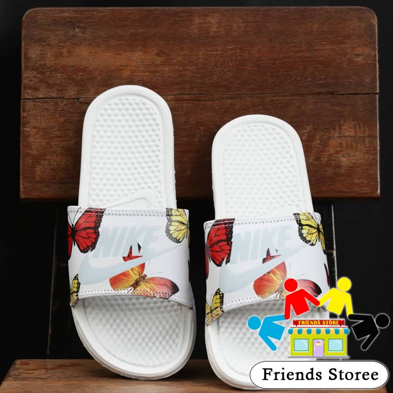 white nike sandals with butterflies