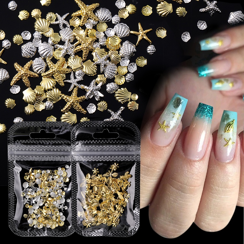 1 Kotak Aksesoris Dekorasi Nail Art DIY Bentuk Kerang / Bintang Laut / Daun Warna Emas / Silver Metalik