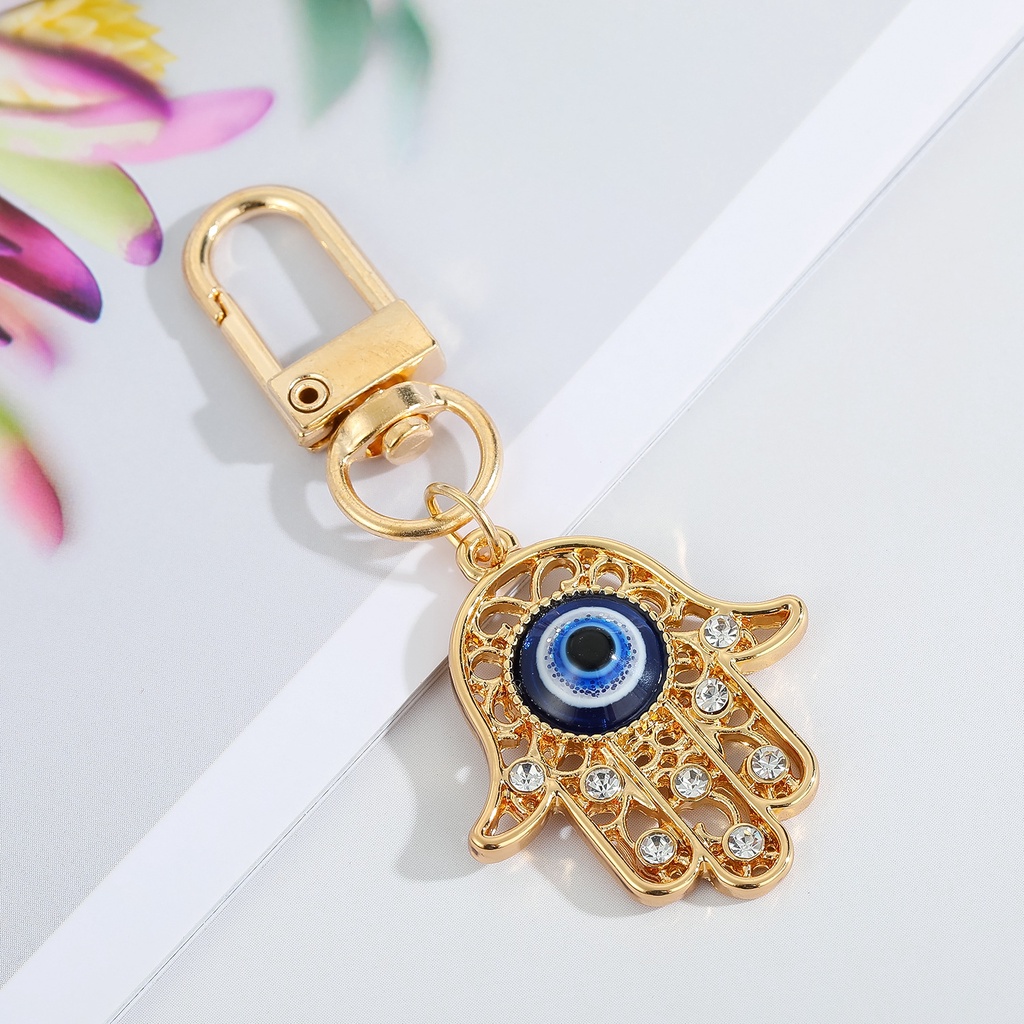 Gantungan Kunci Desain Mata Iblis Bulat Hollow Warna Biru Untuk Pria / Wanita