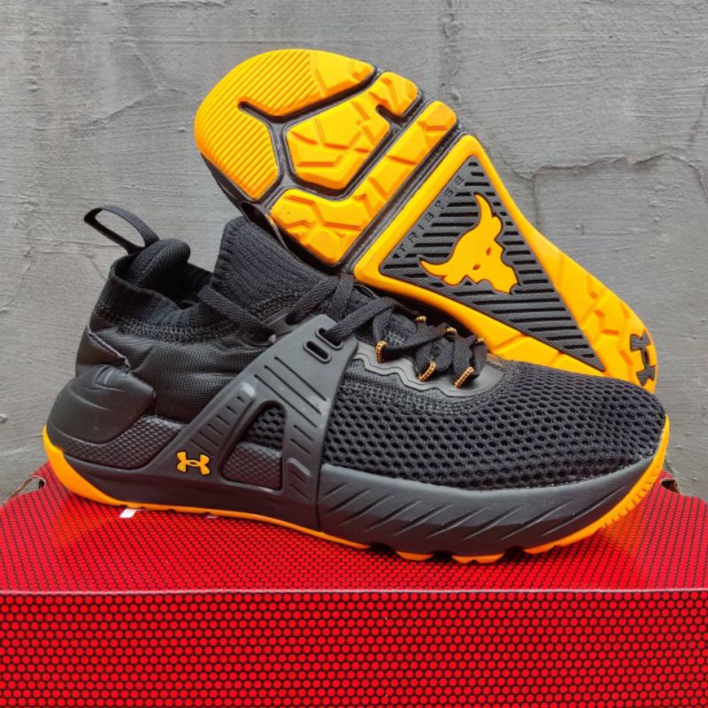 SEPATU UNDER ARMOUR PROJECT ROCK 4 BLACK ORANGE