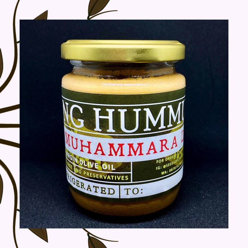 

Jar of Muhammara Dip with extra virgin olive oil - Walnut dip, being hummus