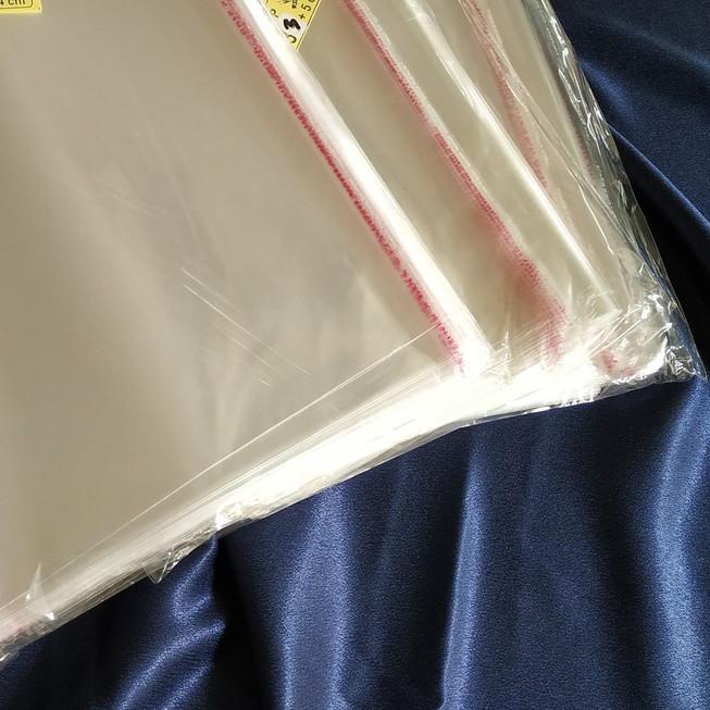 

☎ Plastik OPP 28,5 X 40 CM 20 MIC 100LBR Lem Atau Seal / Plastik bening kemasan bungkus baju gamis celana garment ℮