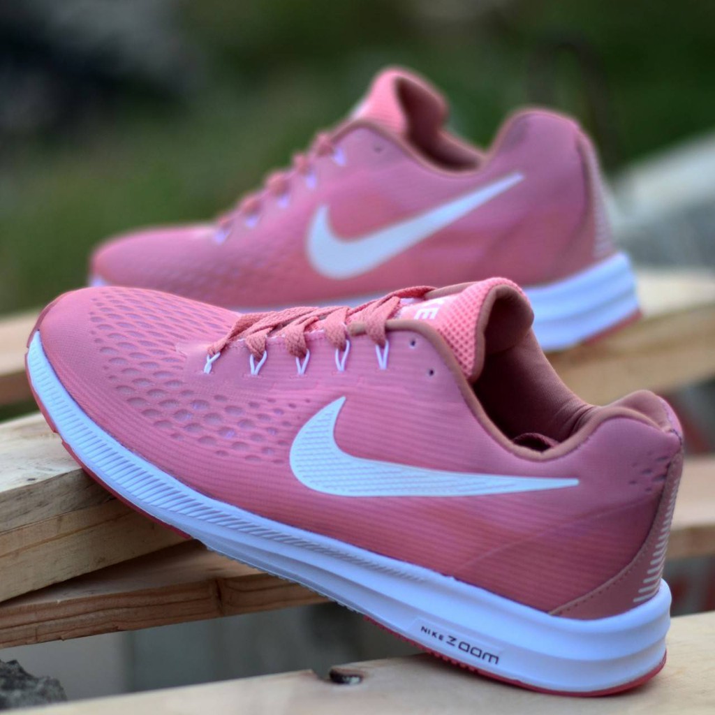 pink and white nike cortez