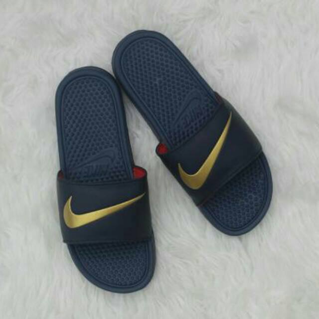 nike flip flops with gold swoosh